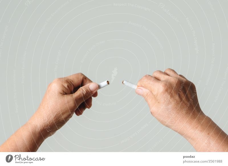Quit smoking, no tobacco day, mother hands breaking the cigarette addict adult aged anti background bad broken care caucasian close up concept cutting danger