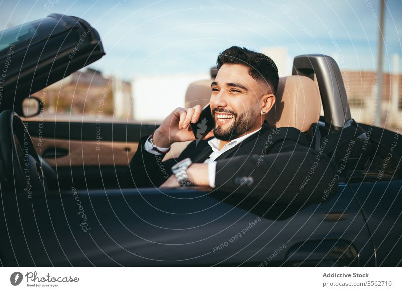 Attractive businessman with convertible car, calling by mobile automobile person people young driver traffic vehicle fashion phone talking success cruise