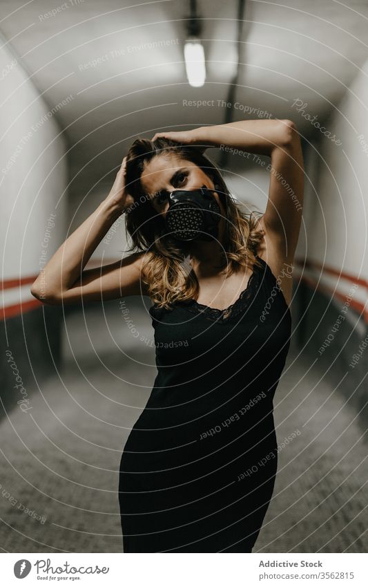 Positive woman in protective mask standing in corridor covid coronavirus prevent positive pandemic concept building safe illness hazard health care cheerful