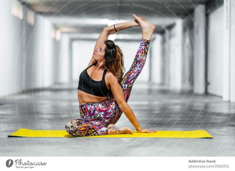 Slim Woman Practicing Yoga On A Mat Indoors Doing Pilates Stretching In A  Pose On The Floor High-Res Stock Photo - Getty Images