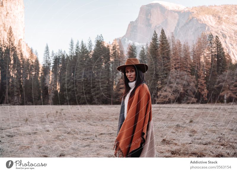 Happy woman enjoying sunny day in mountains travel happy relax forest yosemite park cliff edge rock stone national female style trendy landscape young