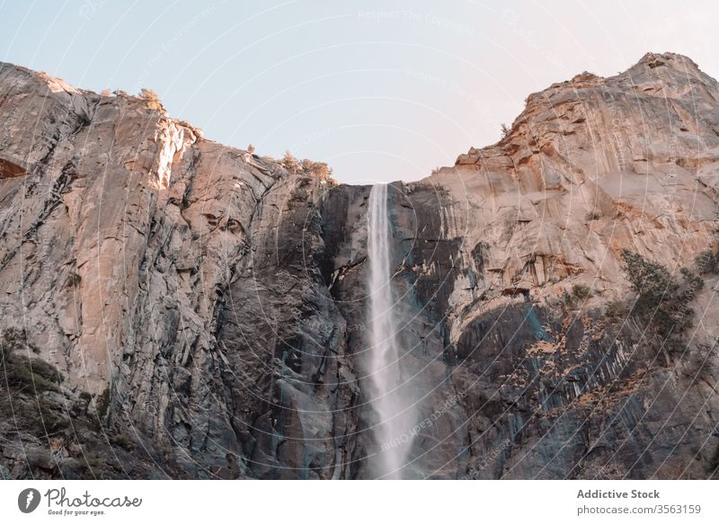 Rough rocky cliff with waterfall mountain rough power stream yosemite national park usa sky nature landscape stone travel tourism california united states