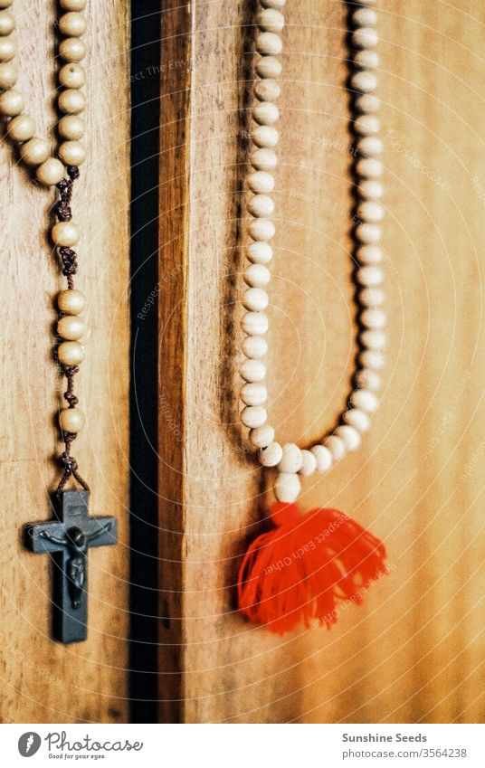 Catholic Rosary and Crucifix hanging on a door Christianity religion church vintage crucifix beads catholic faith prayer rosary wood carving symbolism tradition