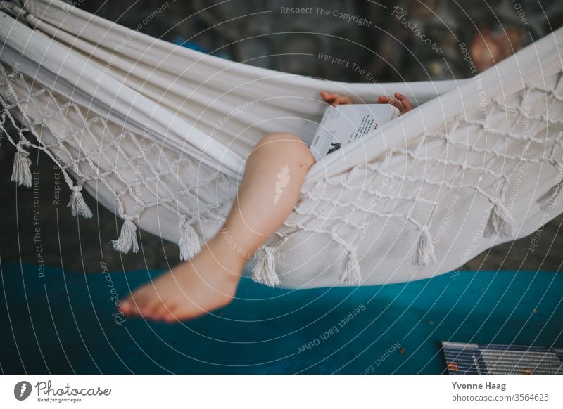 Child lies in a hammock and looks at a book Hawaii Gale Beach Sky Coast Clouds Colour photo Nature Wind Exterior shot Landscape Storm Water Bad weather