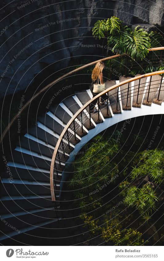 Young woman climbing beautiful stairs with vegetation Stairs up Stone sandstone wall Minimalistic Structures and shapes Pattern Detail Design lines Colour photo