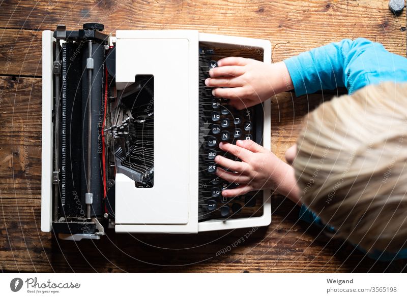 Typewriter with child Child Infancy Study Write Text Letters (alphabet) Typing Literature family life Keypad Keyboard Characters Interior shot Typography