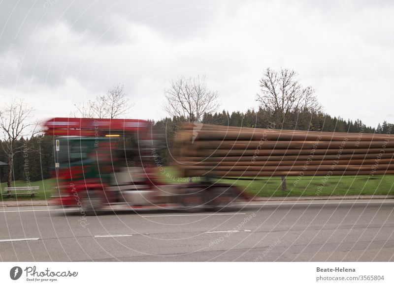 Racy: timber transporter drives its load to its destination at high speed Transporter wood Exterior shot Street Speed swift fast and furious Blur Movement