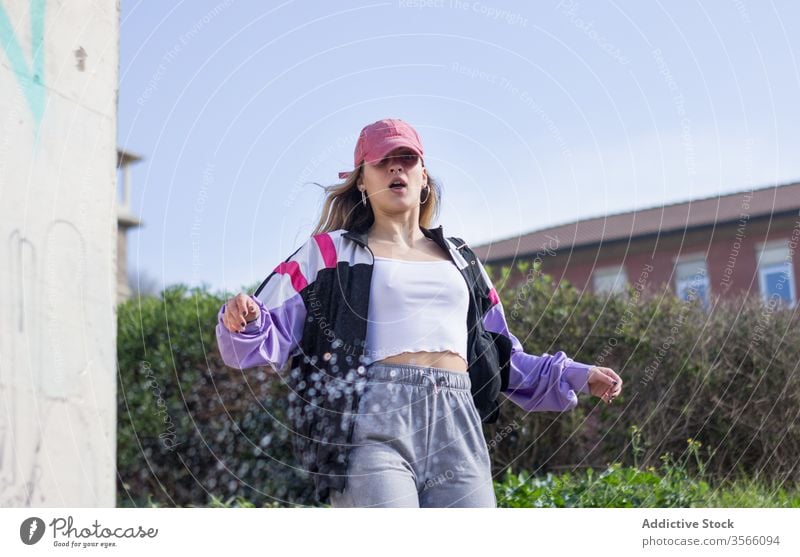 Shocked female millennial on city street shock amazed woman cool modern sportive hipster street style building surprise character young urban trendy outfit