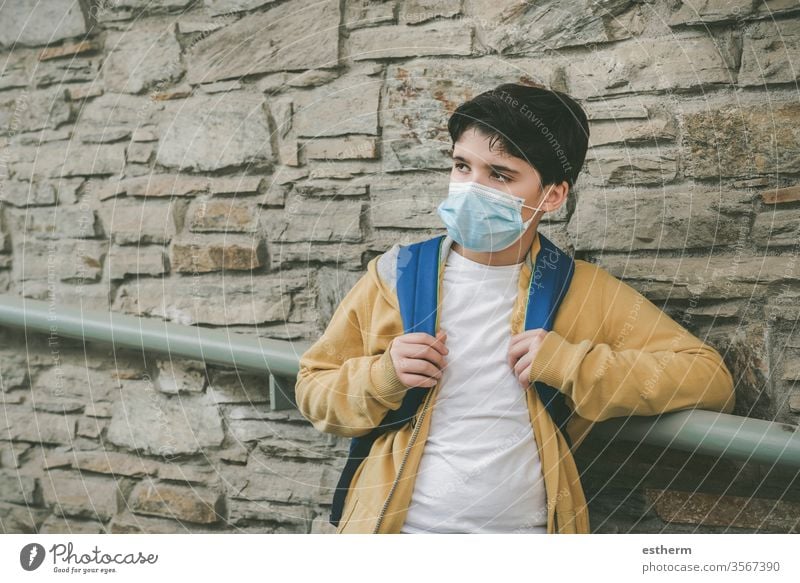 kid with medical mask and backpack waiting at the school door coronavirus Child Virus Epidemic covid-19 School schuler pandemic Quarantine back to school City