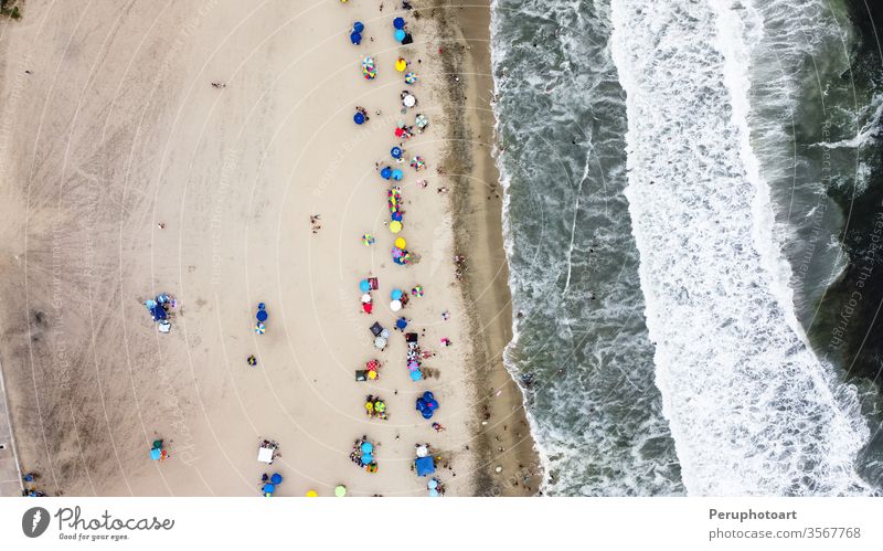Beautiful aerial view with drone to one of the beaches south of Lima in Peru where you can see umbrellas and people enjoying the summer. sand sea nature