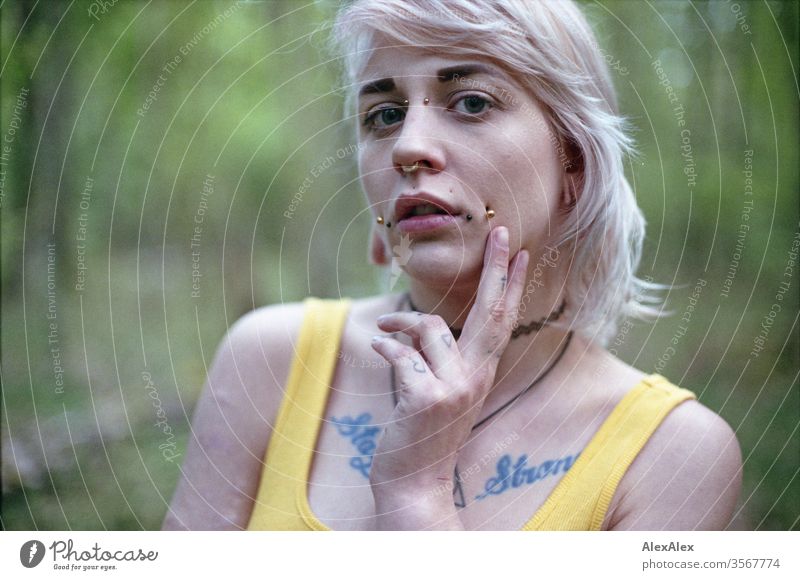 Analogue portrait of a young woman with piercings, tattoos and tunnel Woman girl Blonde Piercing Jewellery Assecoires Shoulder shirt Shirt already out look