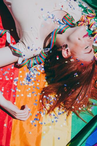 Young redhead woman celebrating gay pride day lgbti party flag rain bow homosexual lesbian color colorful outdoor social issue gender equality society free