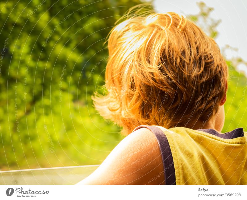 Little boy enjoying sun and wind in a car little child travel skin hair summer sunny day light t-shirt yellow blonde caucasian kid vacation holiday outdoors