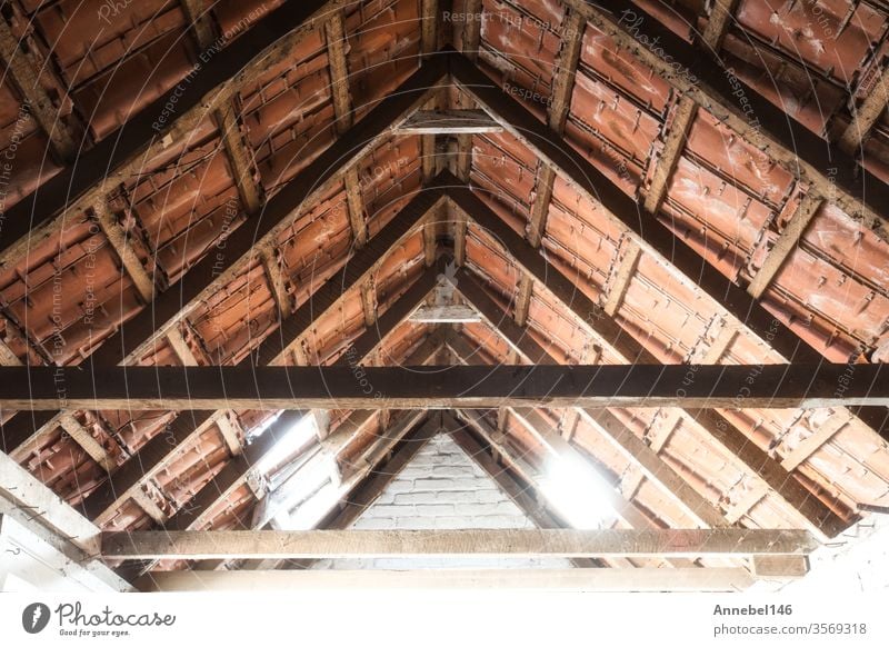 Looking up at the ceiling of an old barn with old roof tiles and wooden beams background grunge design abstract frame retro house pattern sport vintage summer