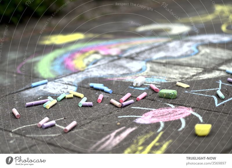A cheerful, colourful childhood dream in soft pastel colours spread out on the cold, grey stones, coloured pieces of chalk were still lying around, but the artist had made herself invisible