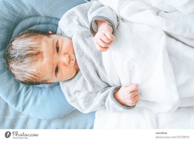 Little new born girl lying down and trying to relax baby birth first day boy mom familly happy happiness care love child daughter son tired sleep sleeping dream