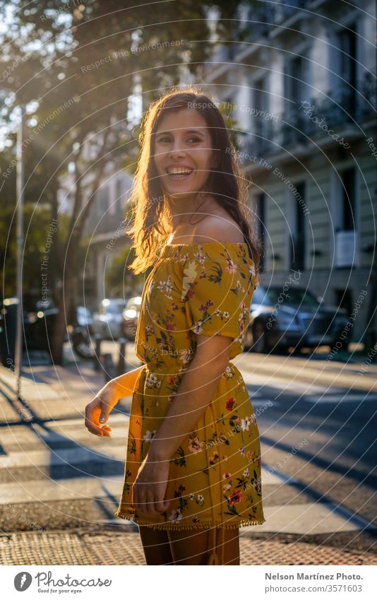 Portrait of a cute model at golden hour, wearing a yellow dress of flower print. portrait fashion bokeh lifestyle lights woman glamour Lifestyle