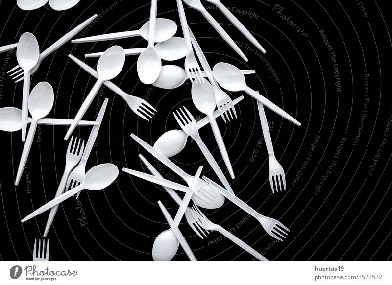Plastic cutlery from above on colored backgrounds plastic top view kitchen dinnerware recycle directly above food natural spoon closeup indoors nobody white cup