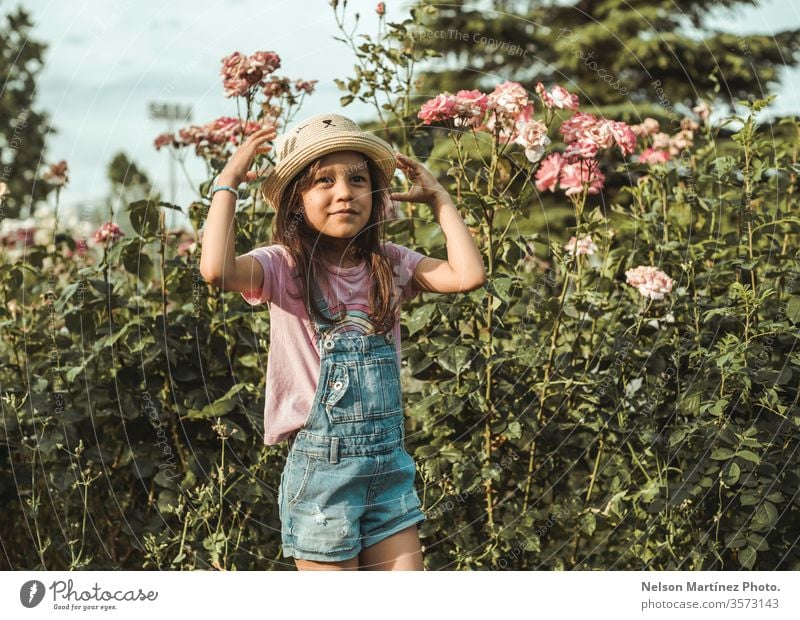 Little girl wearing a cute hat, playing in the park in the summer. little girl child happy grass childhood together nature kids joy people smiling outdoors fun