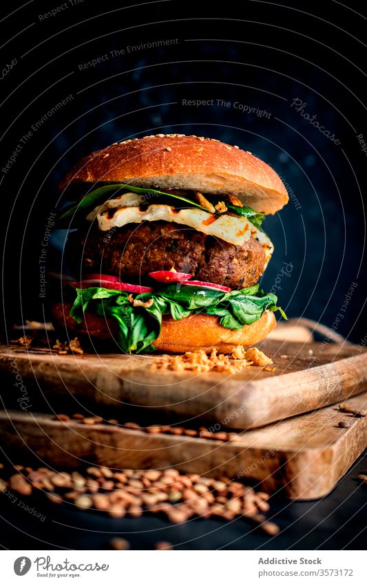 Lentils vegan hamburgers placed on wooden board on dark background gourmet lentil burger veggie burger fast food eating baked delicious natural lifestyle