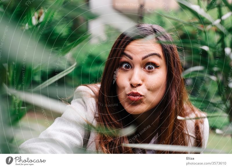Young woman makes a duckface grimace and looks surprised into the camera Duckface portrait Grimace Woman youthful pretty astonished Amazed bunkum girl Face