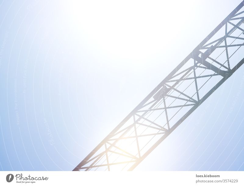Detail of a crane on bright blue sky used for construction, logistics and industry machine manufacturing detail iron building silhouette raise morning transport