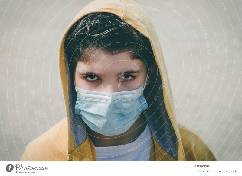 close-up of sad kid wearing medical mask coronavirus child epidemic pandemic thoughtful quarantine covid-19 symptom medicine health death protect childhood