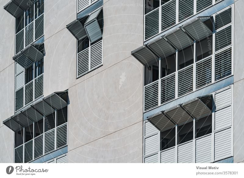 Metallic folding shutters of the facade of a modern residential building window metallic exterior folded sunny daytime urban contemporary architecture