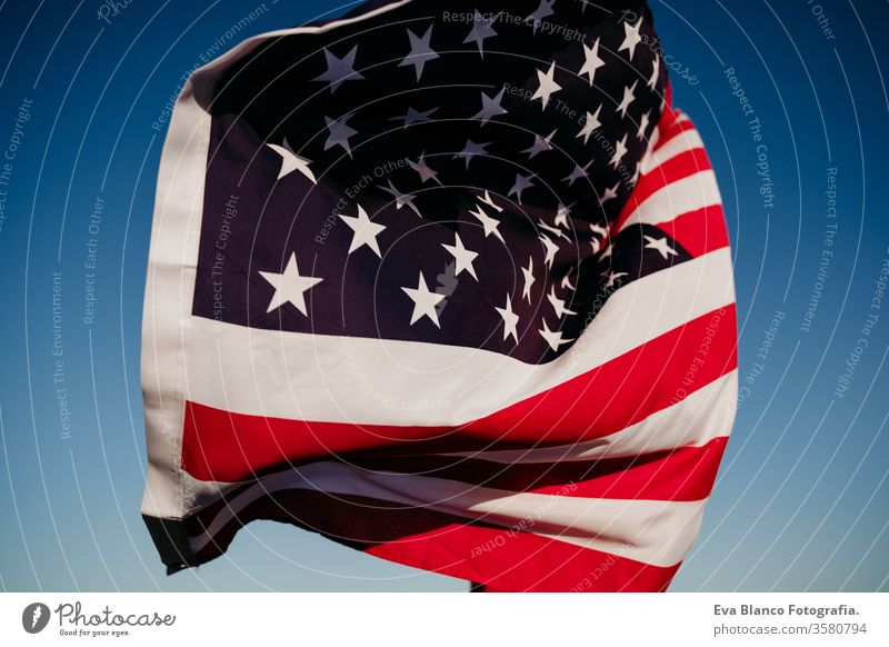 young woman holding United States flag outdoors at sunset. Independence day in America, 4th July concept united states independence day july america freedom