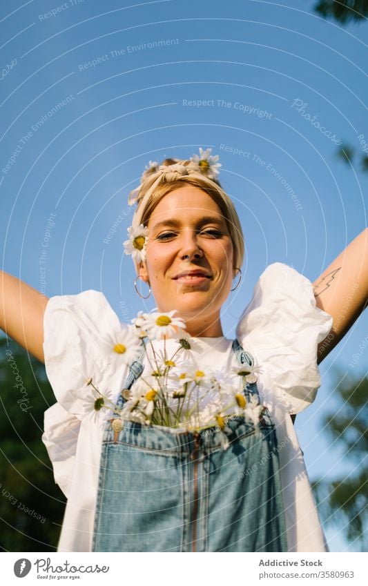 Excited young female with flowers spreading arms in happiness woman bouquet fresh freedom happy summer enjoy excited spread arms arms raised chest chamomile