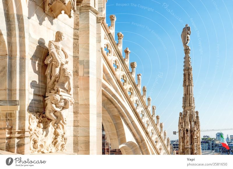 Statues and decoration on roof of Duomo in Milan milan cathedral gothic duomo architecture terrace statues marble beautiful blue sky landmark top italy milano