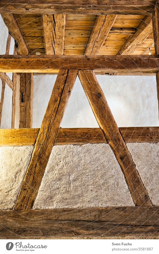 Wooden beams in the interior of a building. Wooden beam construction in "A" shape wooden beams studding Wooden ceiling Blanket Old building refurbishment