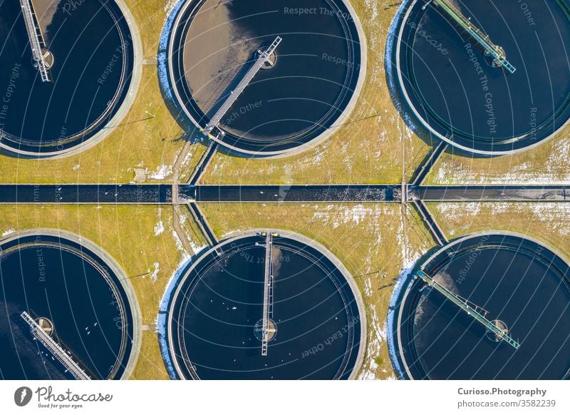Sewage farm. Static aerial photo looking down onto the clarifying tanks. Industrial place. Geometric background texture. Photo captured with drone. treatment