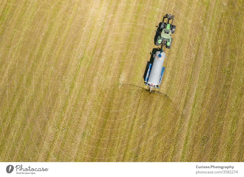 Aerial view of farming tractor plowing and spraying on field.  Agriculture. View from above. Photo captured with drone. aerial machine agriculture harvester