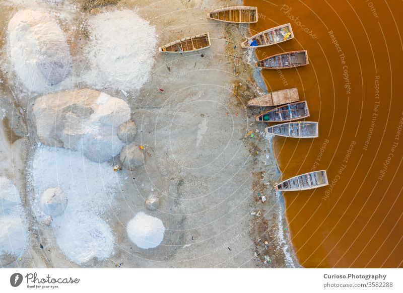 Aerial view of the small boats for salt collecting at pink Lake Retba or Lac Rose in Senegal. Photo made by drone from above. Africa Natural Landscape. senegal