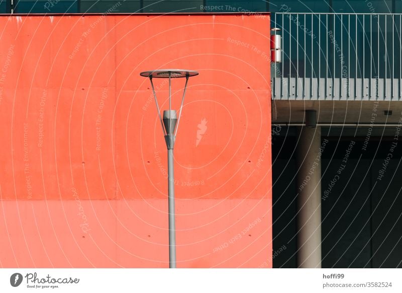 Street lamp in front of red wall Facade Street lighting Pattern dreariness Lantern minimalism Minimalistic built Lamp post Modern Structures and shapes Cladding