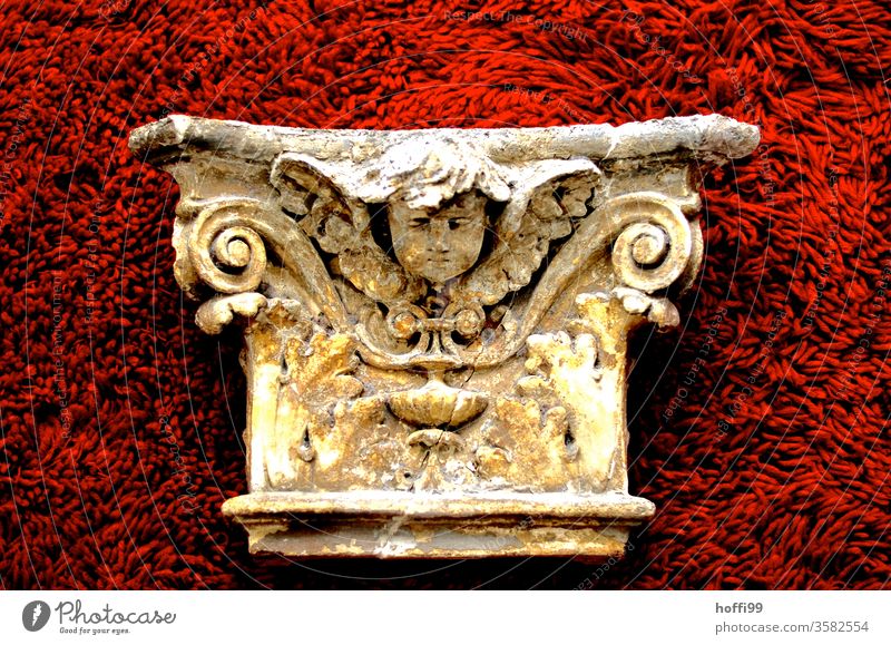 neoclassical facade element with pinched putto - neatly presented on red plush Neoclassicism Sculpture Putto Historic Component Ornament Cladding