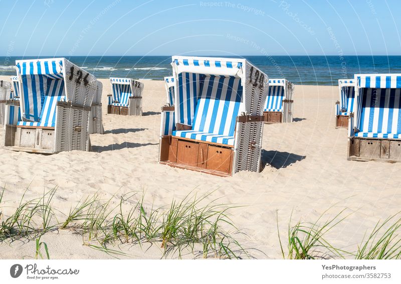 Beach chairs on the sand at the North Sea on Sylt island. Summer vacation Frisian island Schleswig-Holstein Wadden sea beach beach chairs coastline dunes