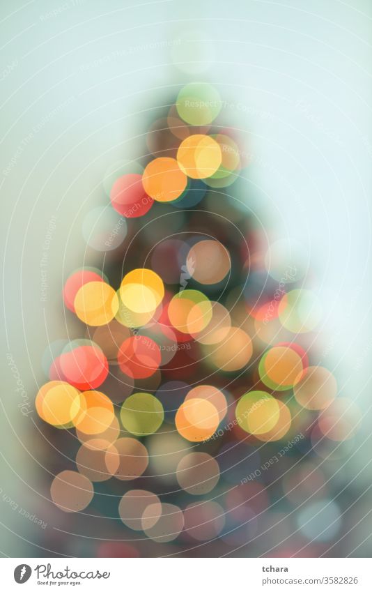 Defocused Christmas tree with lights celebrating holidays fir snowflake snowflakes religion close-up home x-mas magic symbol branch space balls interior happy