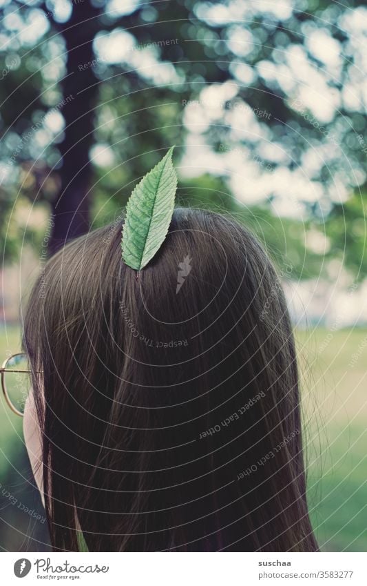 city indian | girl wears a leaf, instead of a feather, in her hair Youth (Young adults) teenager Head Hair and hairstyles brunette fine hair Back of the head