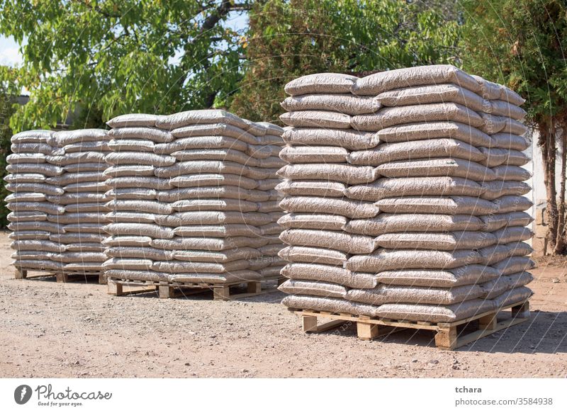 Many sacks that are filled with pellets placed on pallets reserves environmentally storage resources green friendly bags coniferous alternative product domestic