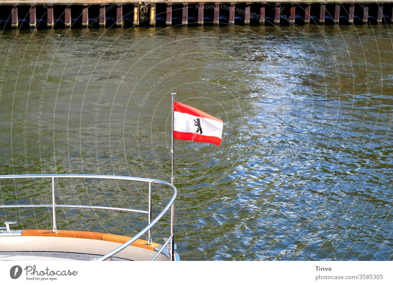 National flag of Berlin bear on the railing of a ship flag of the country Berlin Bear Spree Navigation Tourism quay wall Railing Bow Heraldic animal White Red