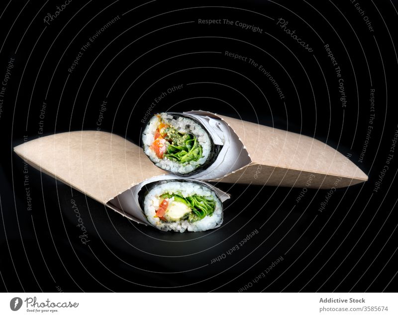 Sushi burritos on black background sushi food snack tradition typical tasty delicious meal authentic cuisine appetizer serve asian mexican fusion dish yummy