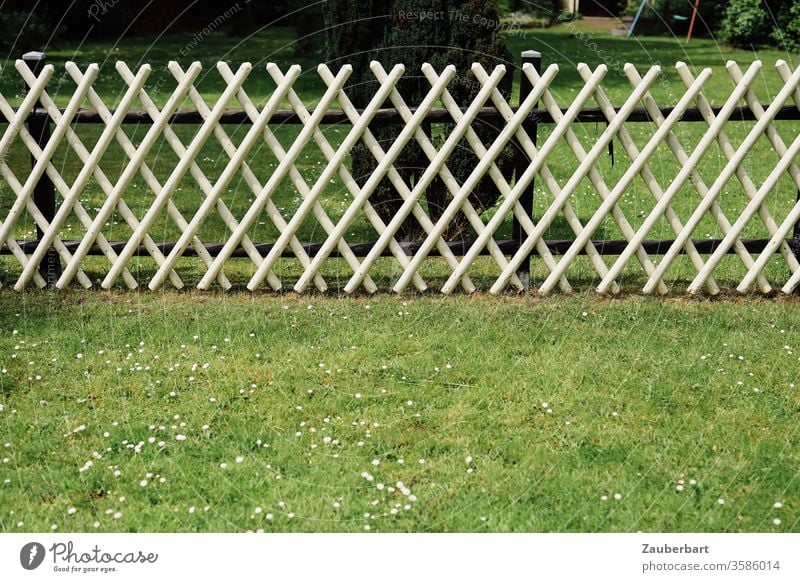 White hunter fence borders and divides a green meadow Fence hunting fence Border Meadow Restrict share Division Pattern rasp Garden Real estate Neighbor Barrier