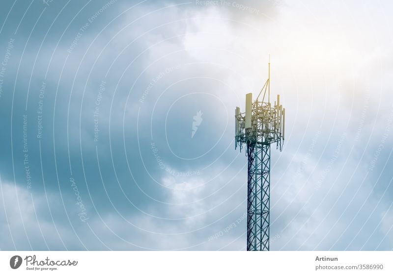 Telecommunication tower with cloudy sky background. Antenna on blue sky. Radio and satellite pole. Communication technology. Telecommunication industry. Mobile or telecom 5g network. Technology