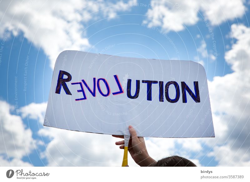 Revolution in the spirit of love. Demonstrator with shield propagates change in the sense of humanity, equality and charity Love Humanity Demonstration