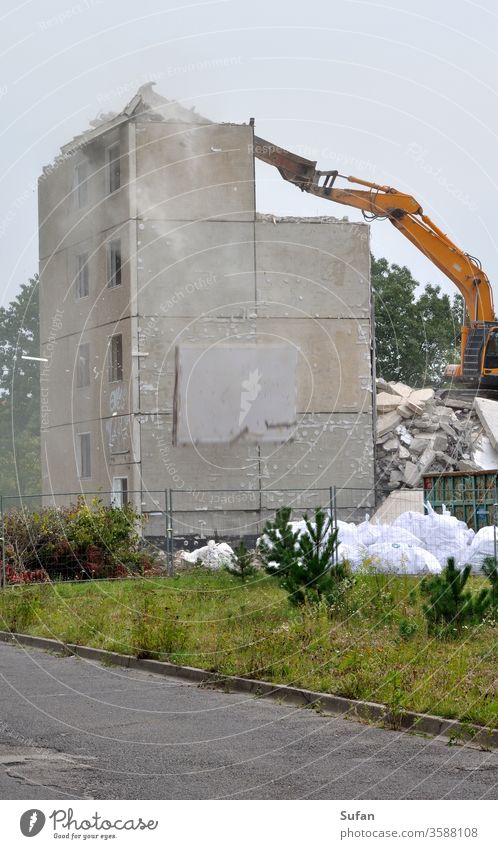 Demolition of a prefabricated building Panel construction flat slabs outline Demolition house Crash Dirty Dusty Dangerous Concrete slab demolition excavator