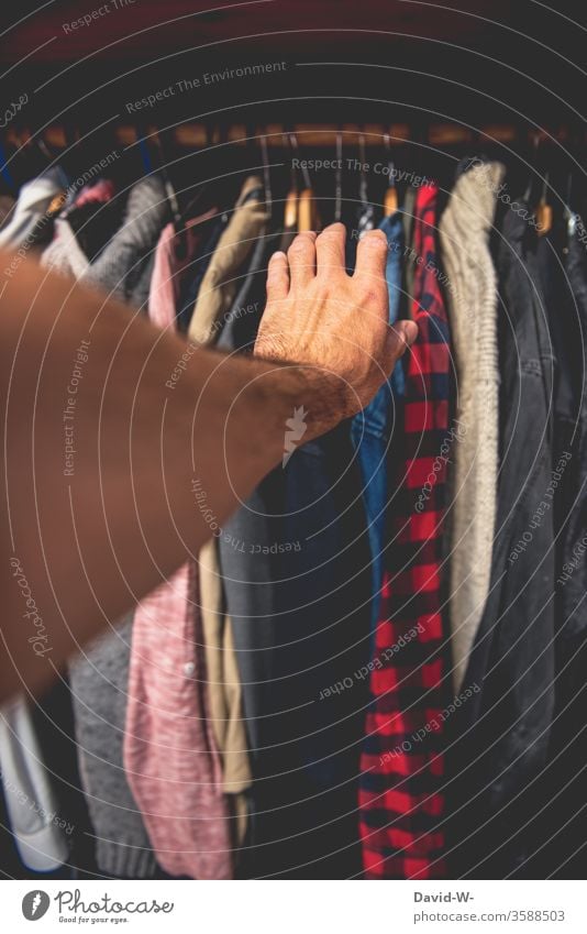 Wardrobe handle by hand garments Attract Closet Hallstand Shirt Grasp Decide Clothing Fashion Interior shot Style hang Hanger Colour photo Living or residing