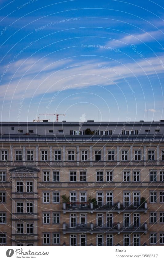 Sky over Berlin Facade House front Apartment house tenement houses Balconies Roof terrace Construction crane Blue sky Clouds Cirrus cloud Summer warm