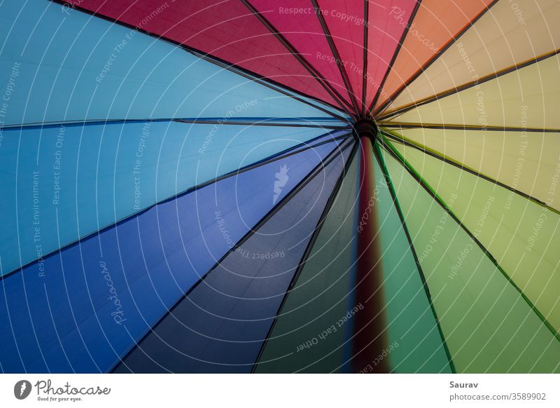A Rainbow color Umbrella. Colors that also represent LGBT pride flag and equality. colorful rainbow umbrella vibgyor black lives matter gay pride flag